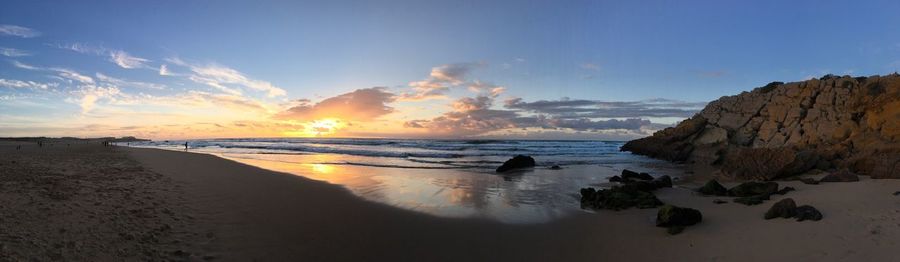 Panoramic view of beach against sky during sunset