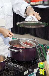 Midsection of man preparing food