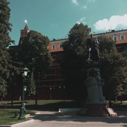 Trees and buildings against sky in city