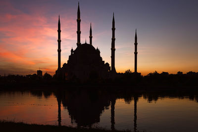 Reflection of buildings in water at sunset