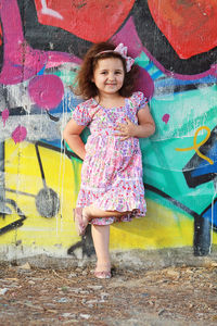 Portrait of smiling girl playing with umbrella