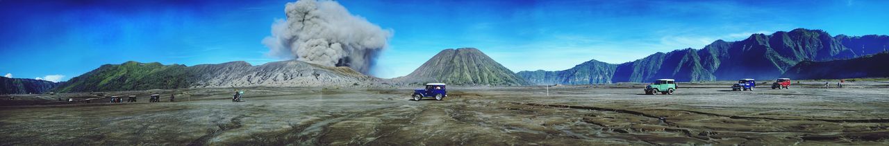 Panoramic view of people on mountain against sky