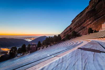 Amphitheater against clear blue sky during sunset