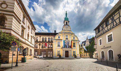 Street amidst buildings against sky in city