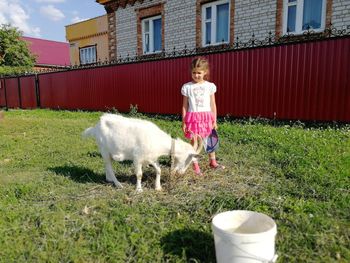 Full length of a girl standing by plants