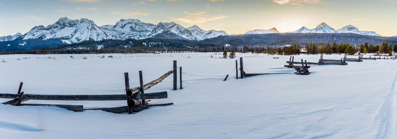 Scenic view of snow covered field against sky