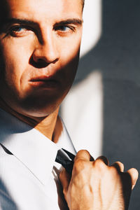 Close-up portrait of man holding camera