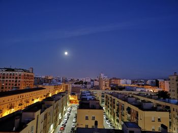 High angle view of illuminated buildings against sky at night