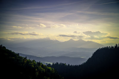 Scenic view of silhouette mountains against sky at sunset