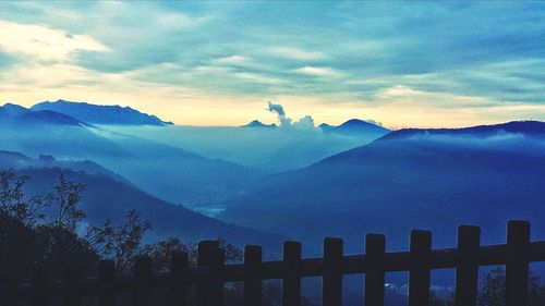 Scenic view of mountains against cloudy sky