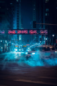 Illuminated city street at night