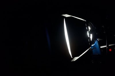 Close-up of illuminated lamp in darkroom