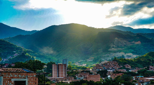 Townscape by mountains against sky