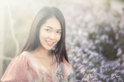 Portrait of a smiling young woman outdoors