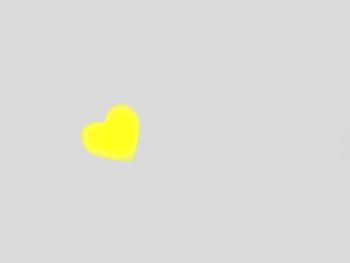 Close-up of yellow heart shape on white background