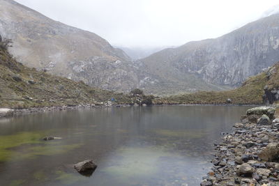 Scenic view of lake and mountains against sky