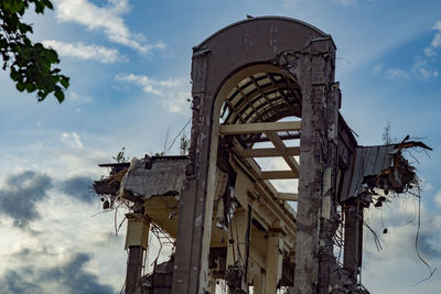 Low angle view of abandoned building against sky