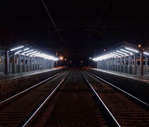 Illuminated railroad station and tracks