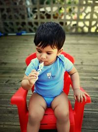 Cute boy sitting outdoors