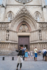Rear view of people walking outside building