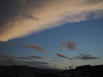 Low angle view of buildings against sky at sunset