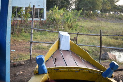 Close-up of playground against trees on field