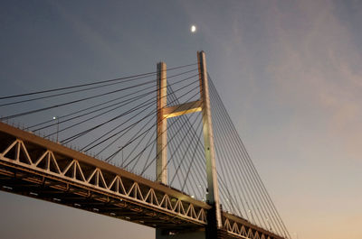 Low angle view of suspension bridge against sky