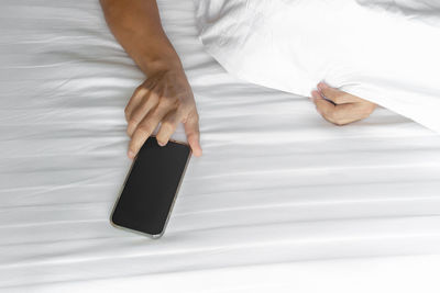 High angle view of woman relaxing on bed