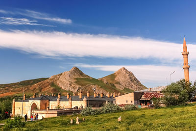 Houses on mountain against sky