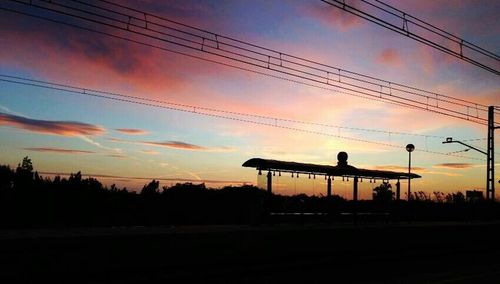 Silhouette of power lines at sunset