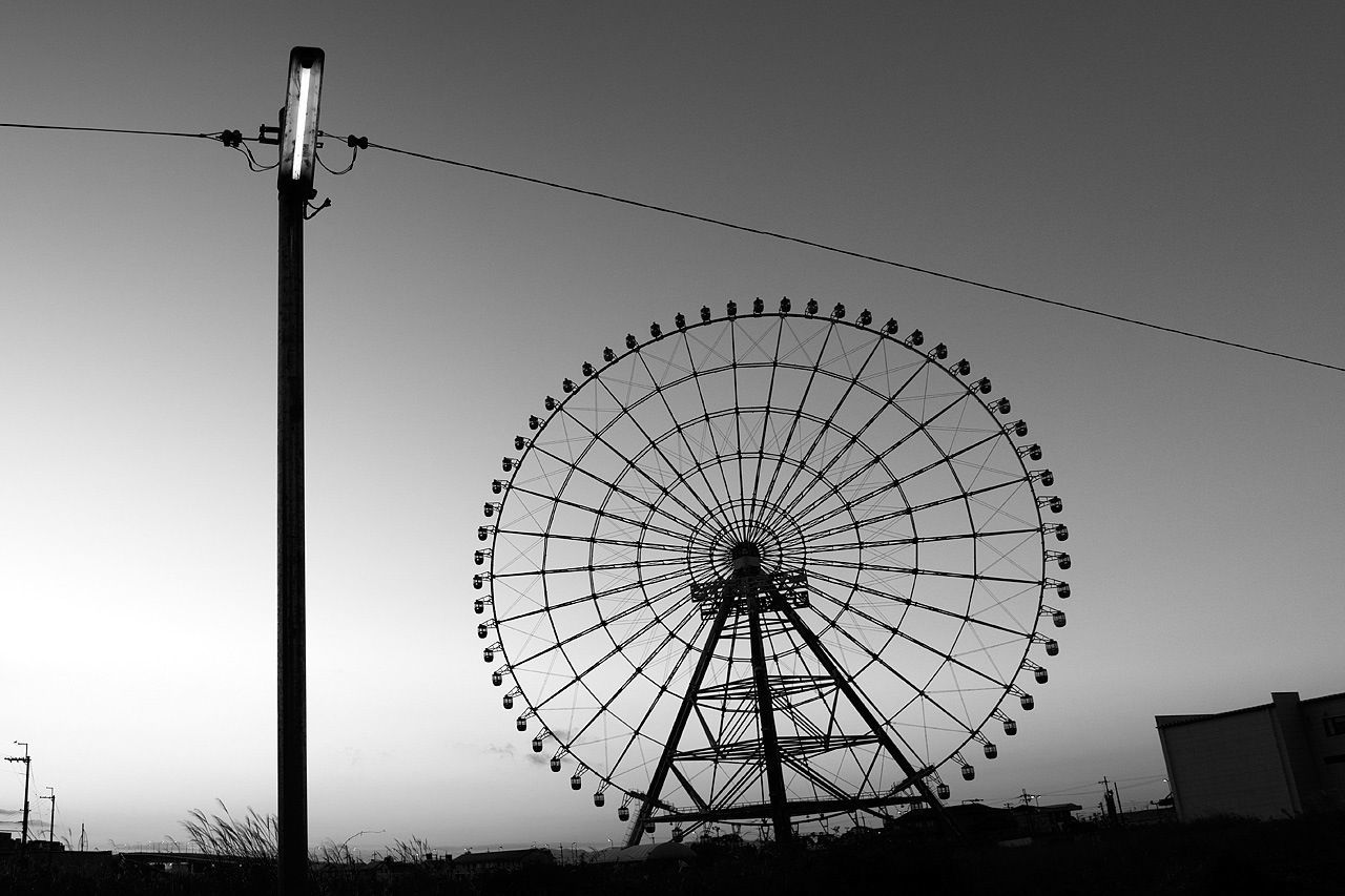 ferris wheel, amusement park, low angle view, amusement park ride, arts culture and entertainment, clear sky, silhouette, sky, built structure, outdoors, day, architecture, circle, electricity pylon, connection, no people, large, copy space, dusk, rollercoaster