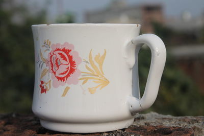 Close-up of coffee cup on wall