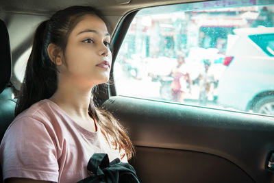 Young woman sitting in car