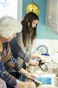 Young woman standing in kitchen at home