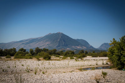 Scenic view of mountains against clear blue sky