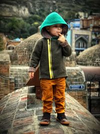 Full length of boy in warm clothes standing outdoors