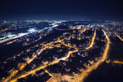 High angle view of illuminated buildings in city at night