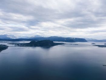 Aerial view of a nordic coast, seaside, seashore, island, horizon over sea, white clouds, high up 