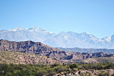 Scenic view of mountains against clear blue sky