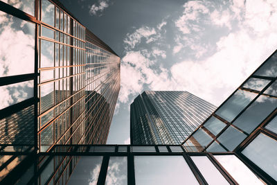 Directly below shot of modern glass building against sky