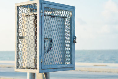 Close-up of metallic structure against sea