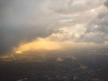 Aerial view of city against dramatic sky