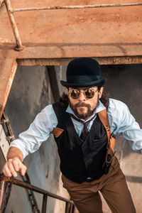 Portrait of man holding hat