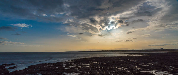 Scenic view of sea against cloudy sky