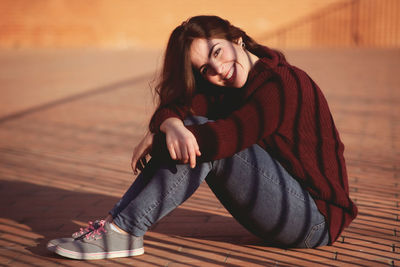 Portrait of smiling woman sitting outdoors