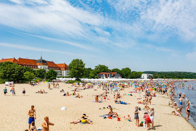 People at beach against sky