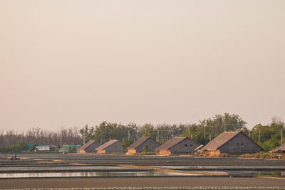 Houses by road against clear sky