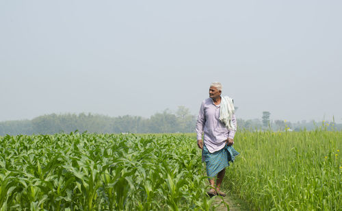 Full length of indian farmer standing on field