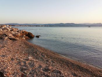 Scenic view of sea against clear sky during sunset