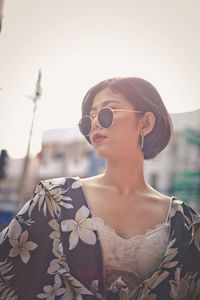 Woman wearing sunglasses in city